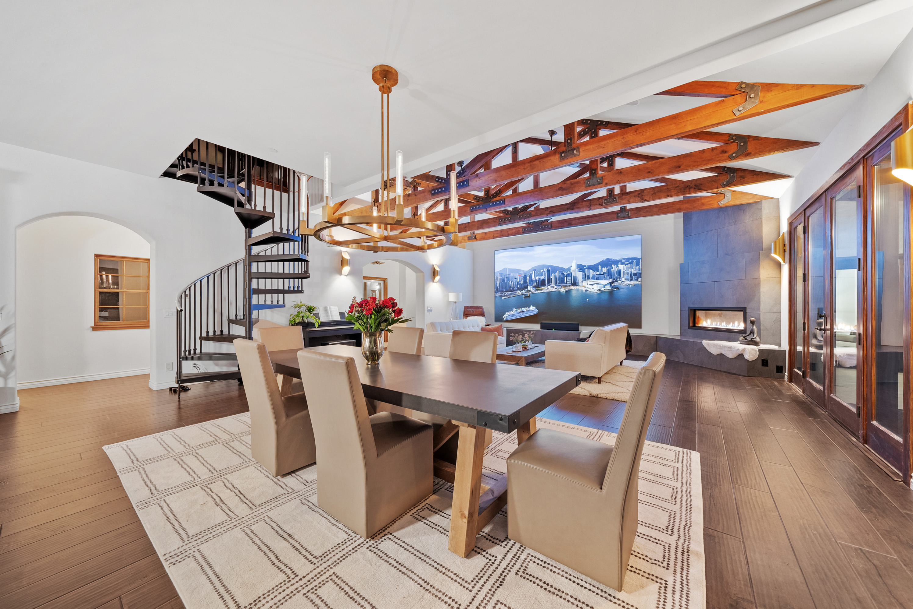 Dining room with spiral staircase and exposed trusses