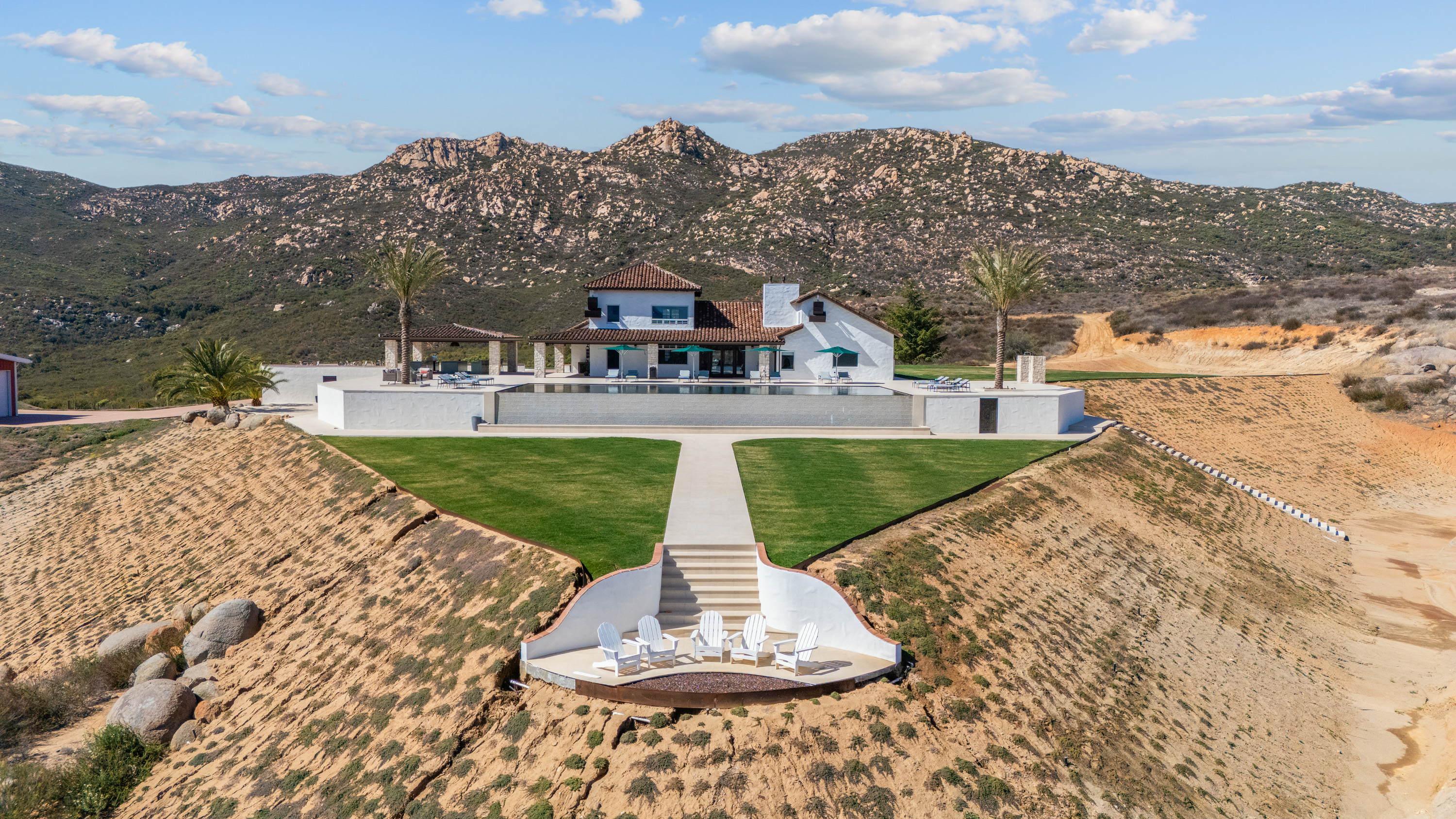 Aerial showing fire pit axis, lawn, pool and mountains