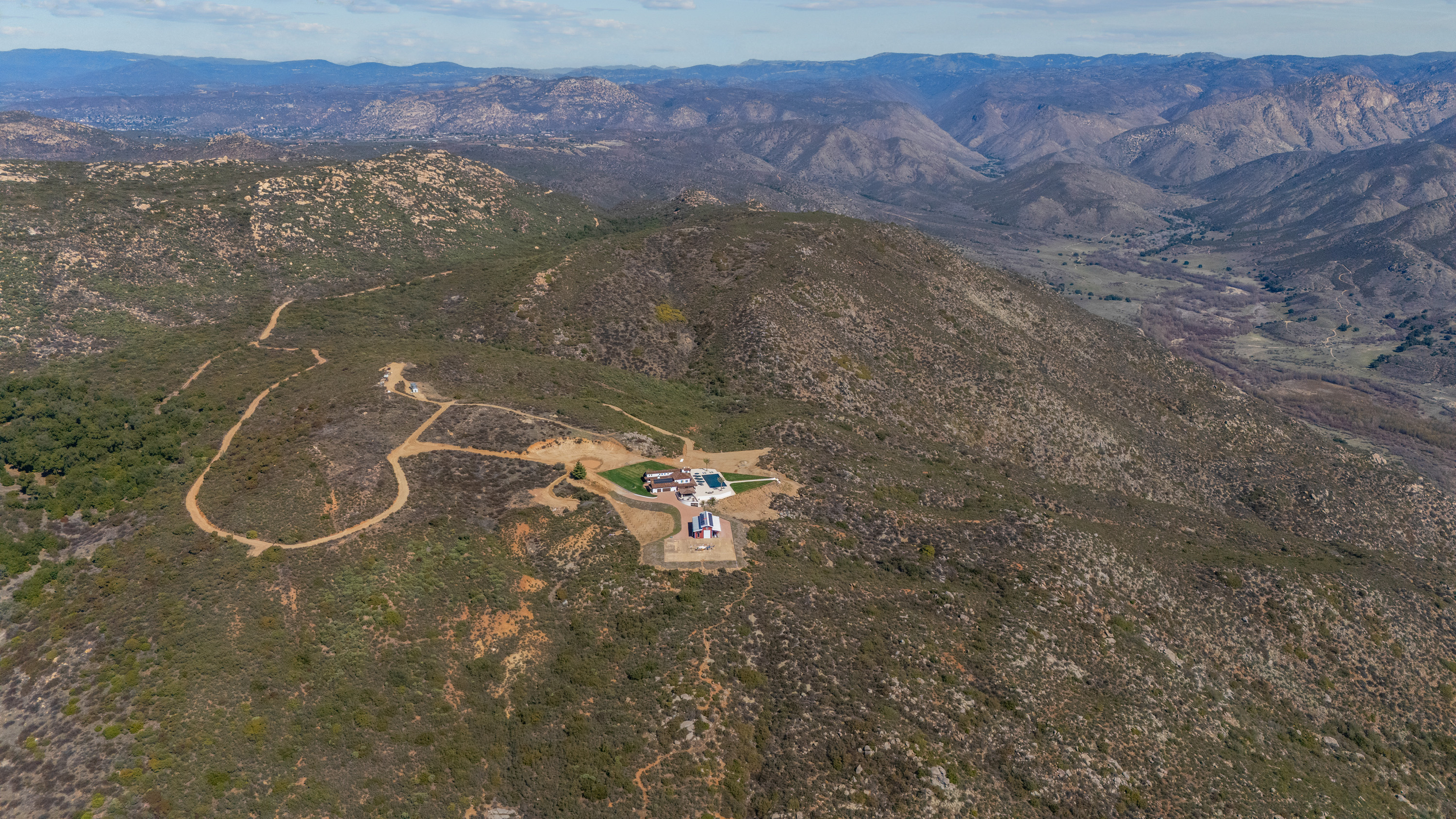 Aerial view of compound with valley and mountain ranges